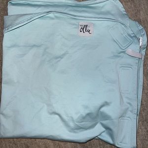 Brand new blue Ollie brand swaddle.
